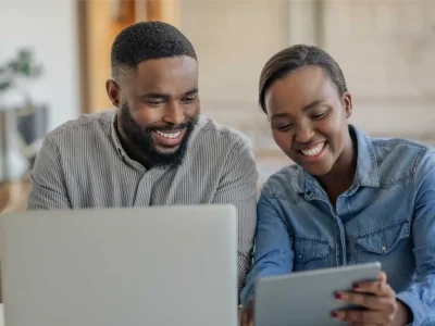 people smiling and looking at mobile devices