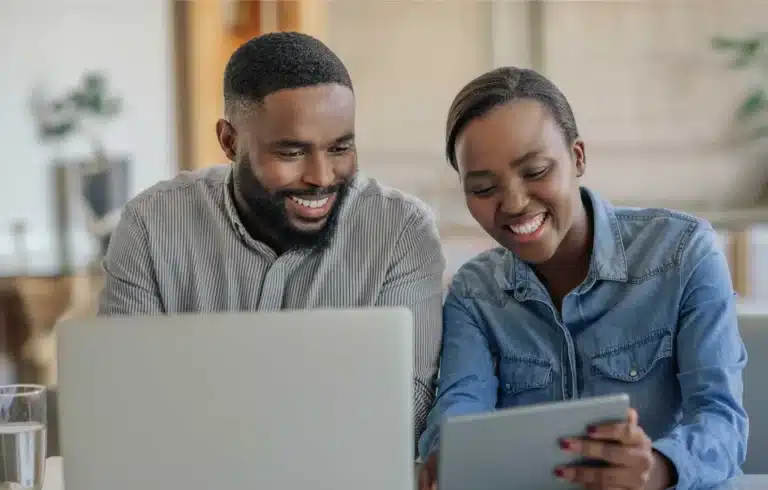 people smiling and looking at mobile devices